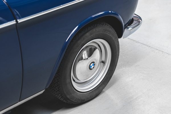 Close view of wheel with BMW badge on BMW 2002 1968 Pacific Blue.