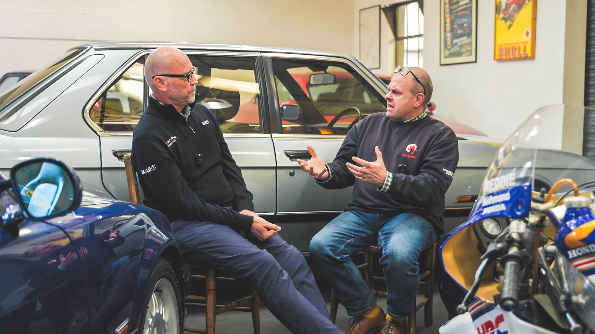 Barney and Chris sit in the hero motor company showroom and talk on a podcast.