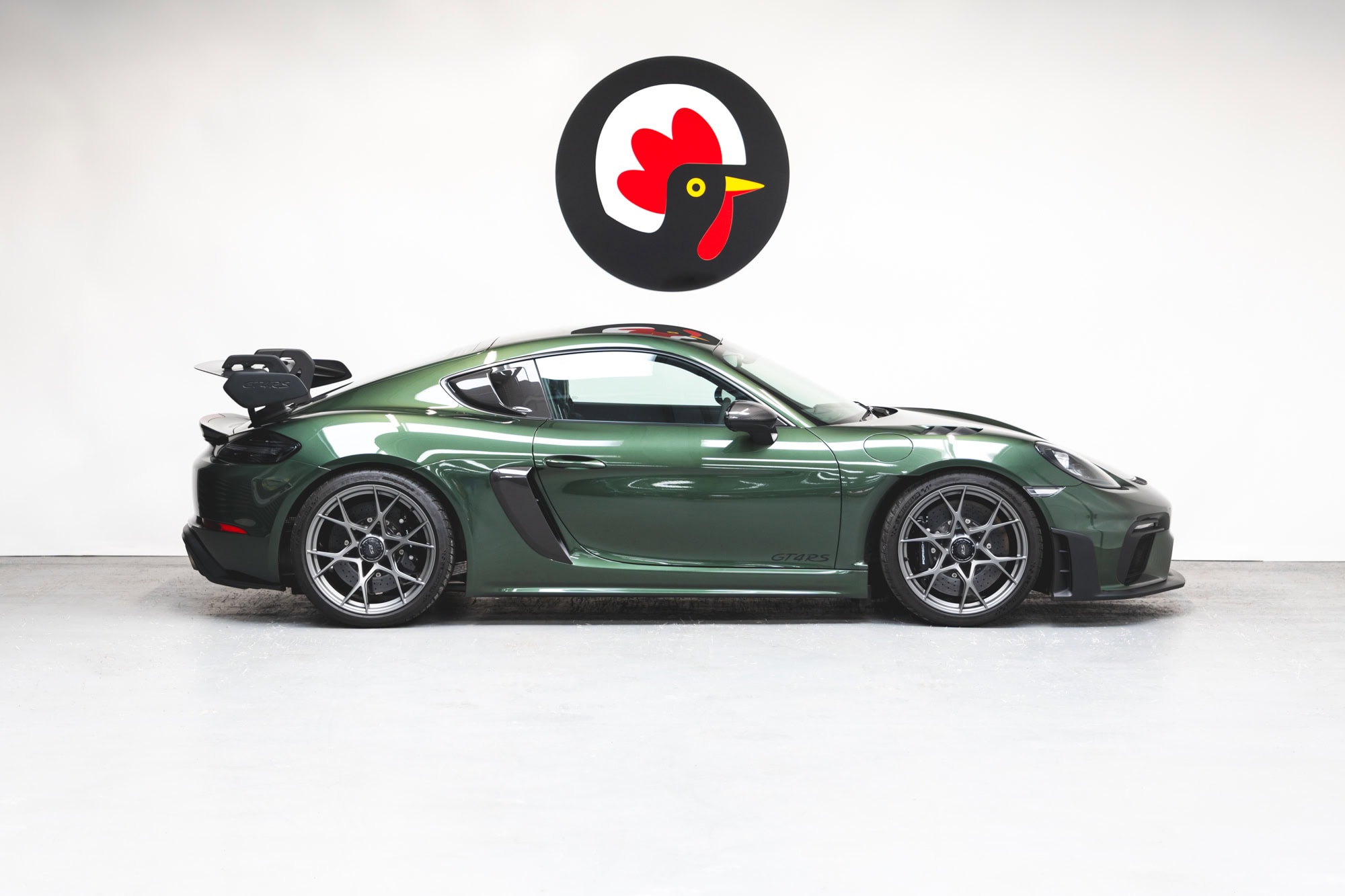 Offside exterior of Porsche GT4 RS Oak Green Weissach showing alloy wheels and rear spoiler.