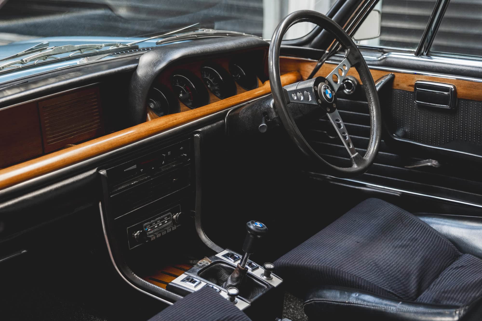 Nearside view of steering wheel and centre console on BMW 3.0 E9 CSL Fjord Blue.