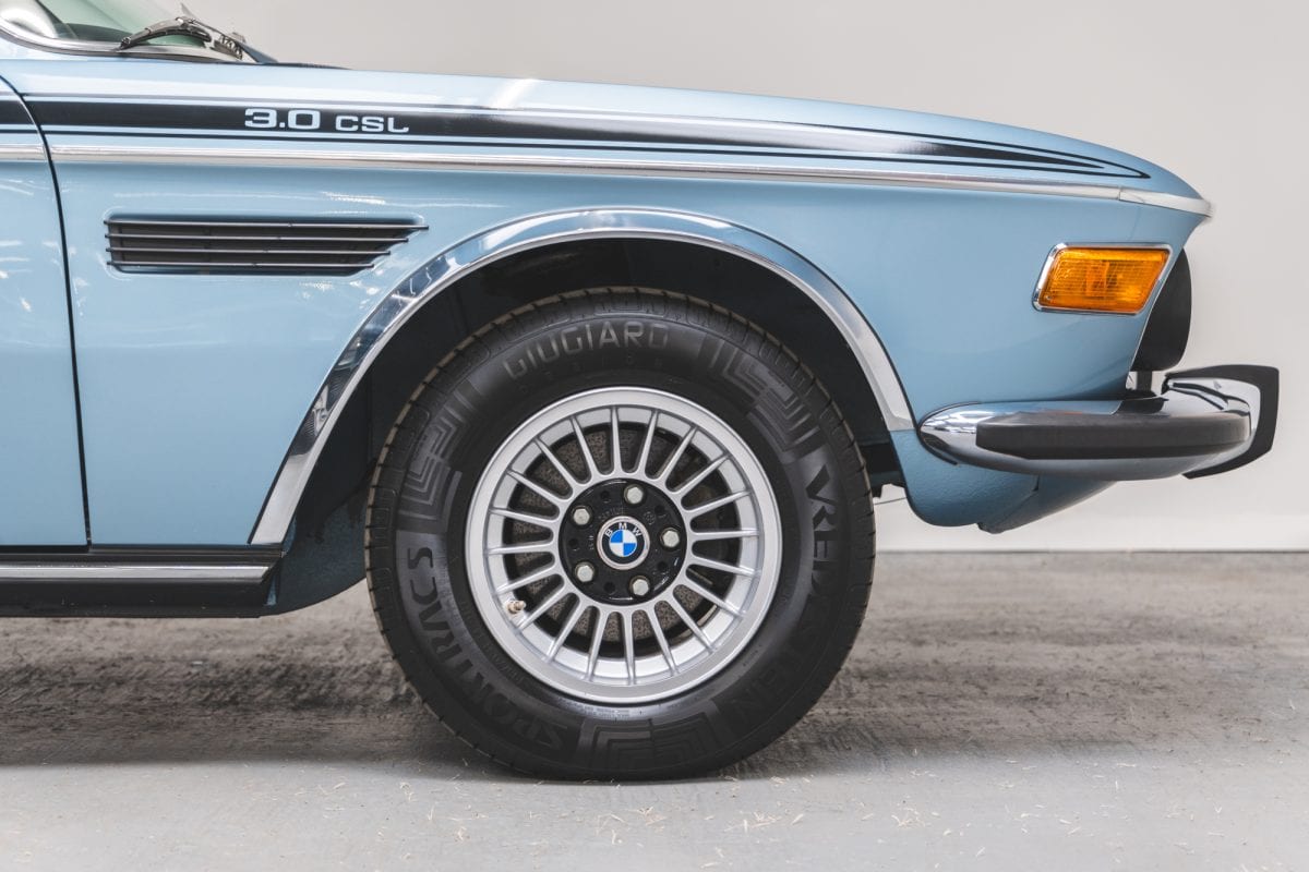 Close up view of alloy wheel and chrome trim on BMW 3.0 E9 CSL Fjord Blue.