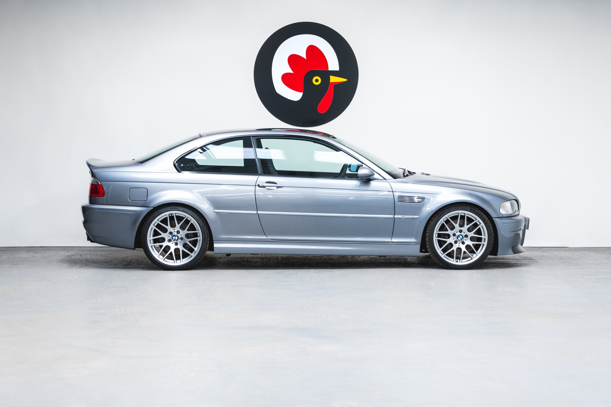 Offside profile view of a BMW E46 M3 CSL in silbergrau.