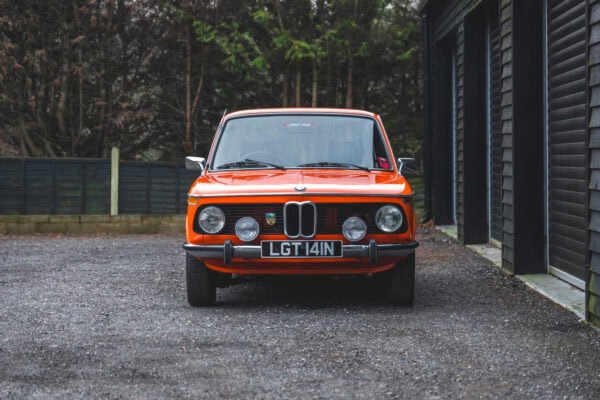 Front exterior view of BMW 2002 tii Inka Orange.