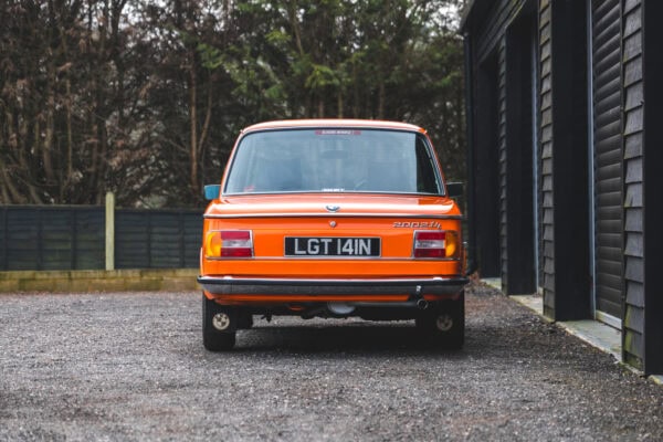 Rear showing BMW mudflaps chrome bumper boot lid on BMW 2002 tii Inka Orange.