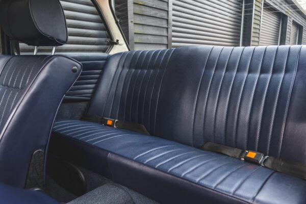 Leather rear seats and seat belts in BMW 2002 tii Inka Orange.