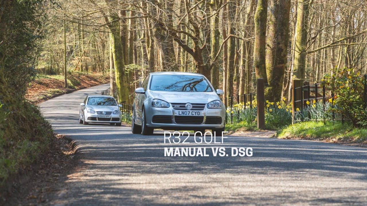 Two silver mk5 Volkswagen Golf r32's chase each other down a country road.