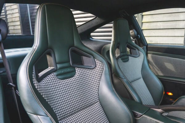 A Porsche with custom green leather and houndstooth fabric.