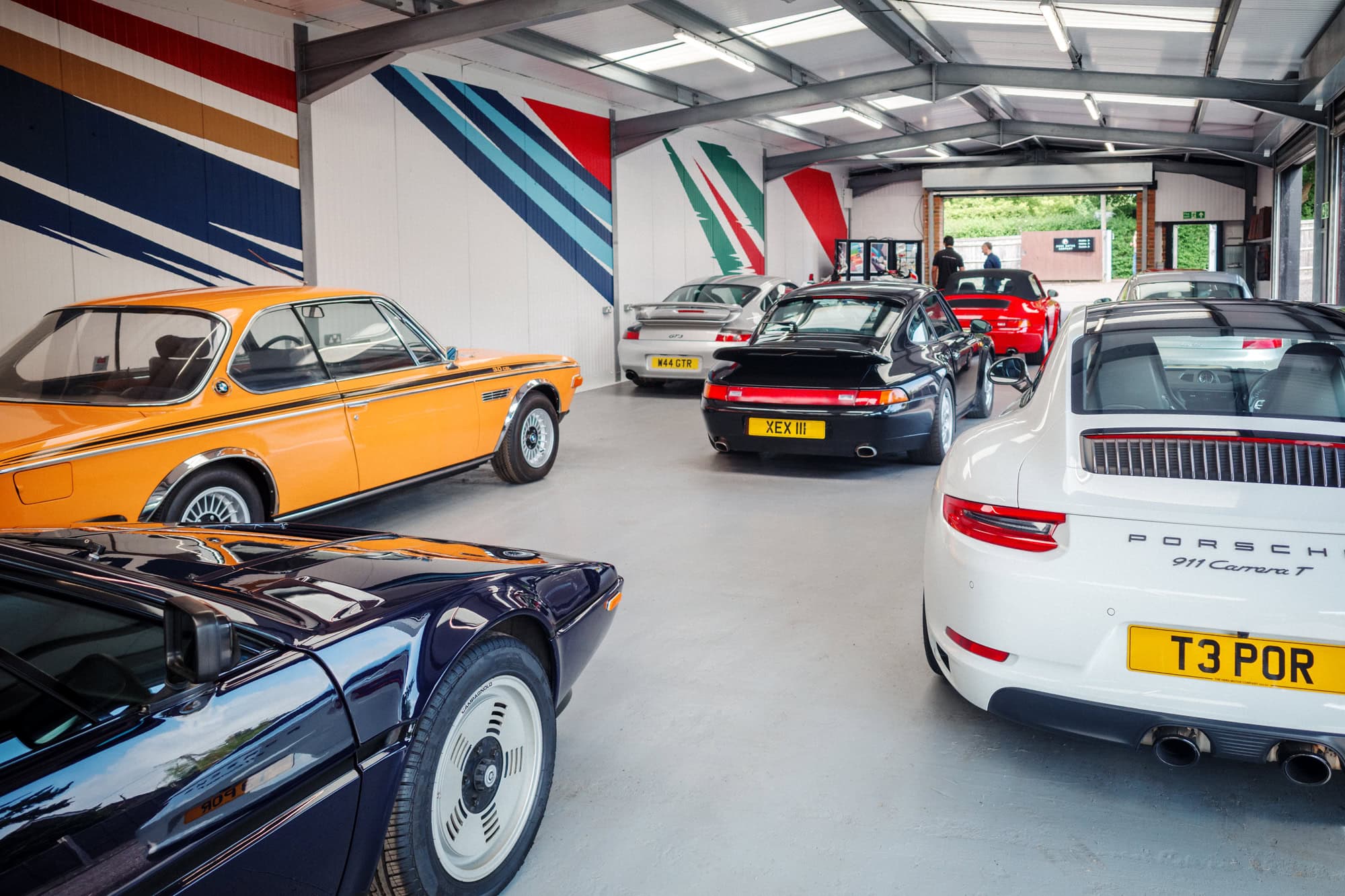 A collection of rare BMW and Porsche on display at a hero motor company open day.