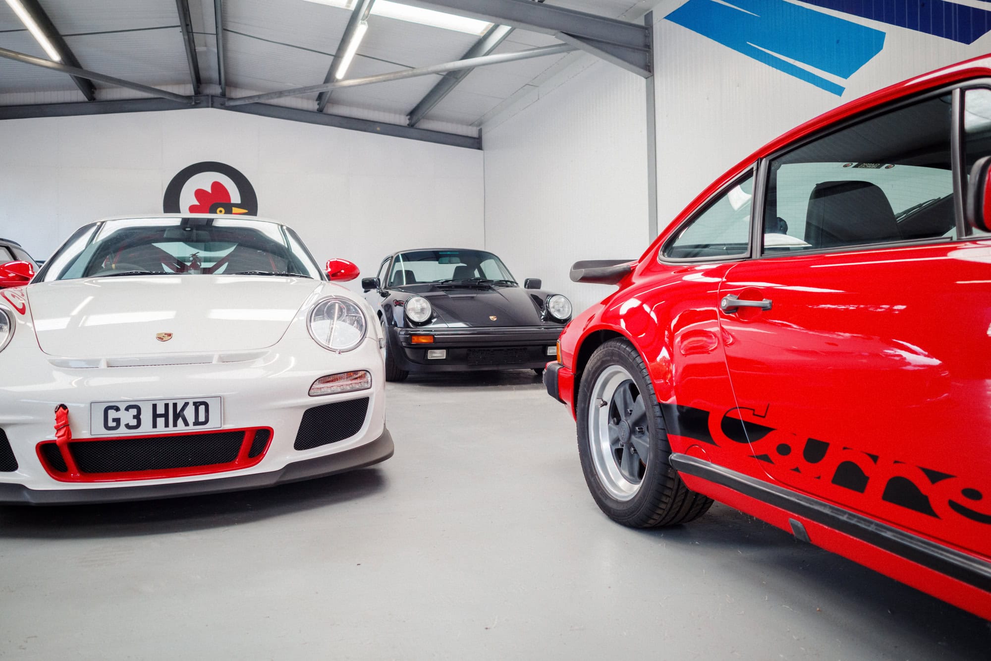 Three Porsches on display at a Porsche meet.