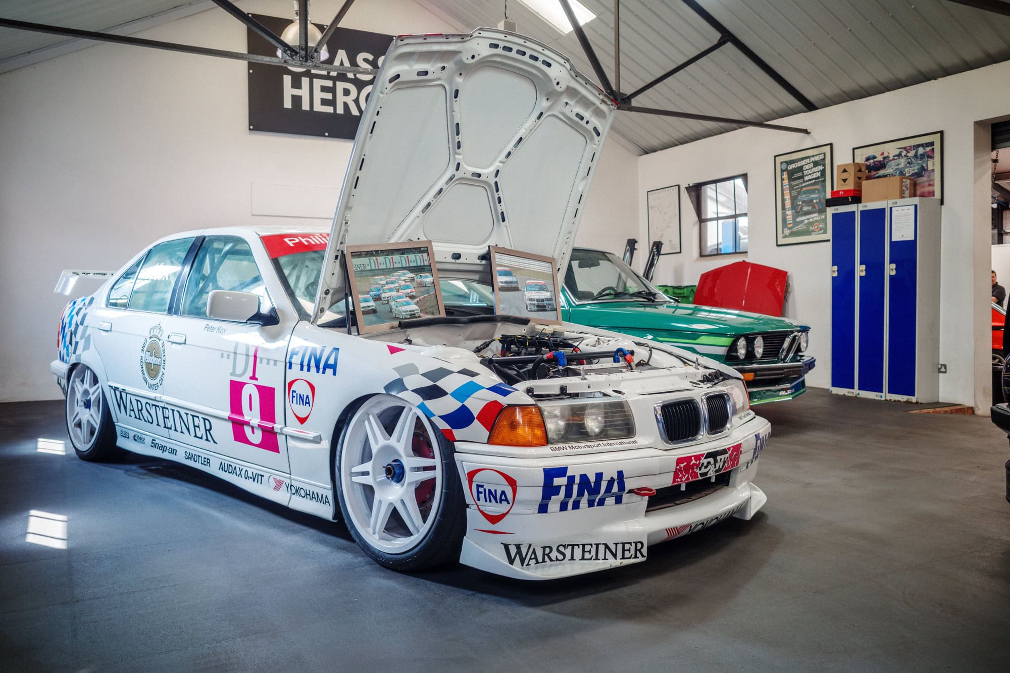 A BMW E36 super tourer BTCC racing car with the bonnet up.