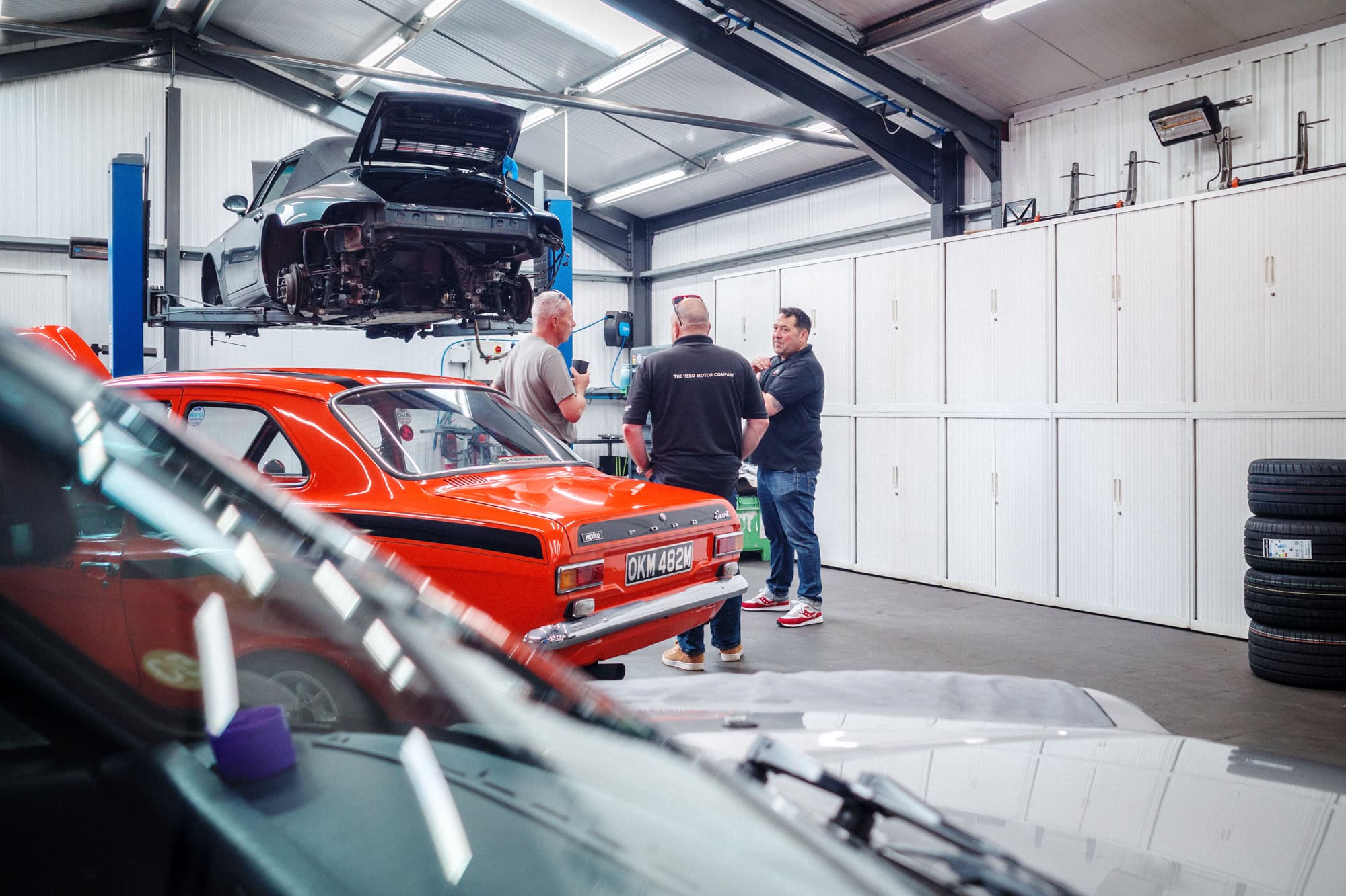 A customer talking to a mechanic in the workshop at hero motor company.