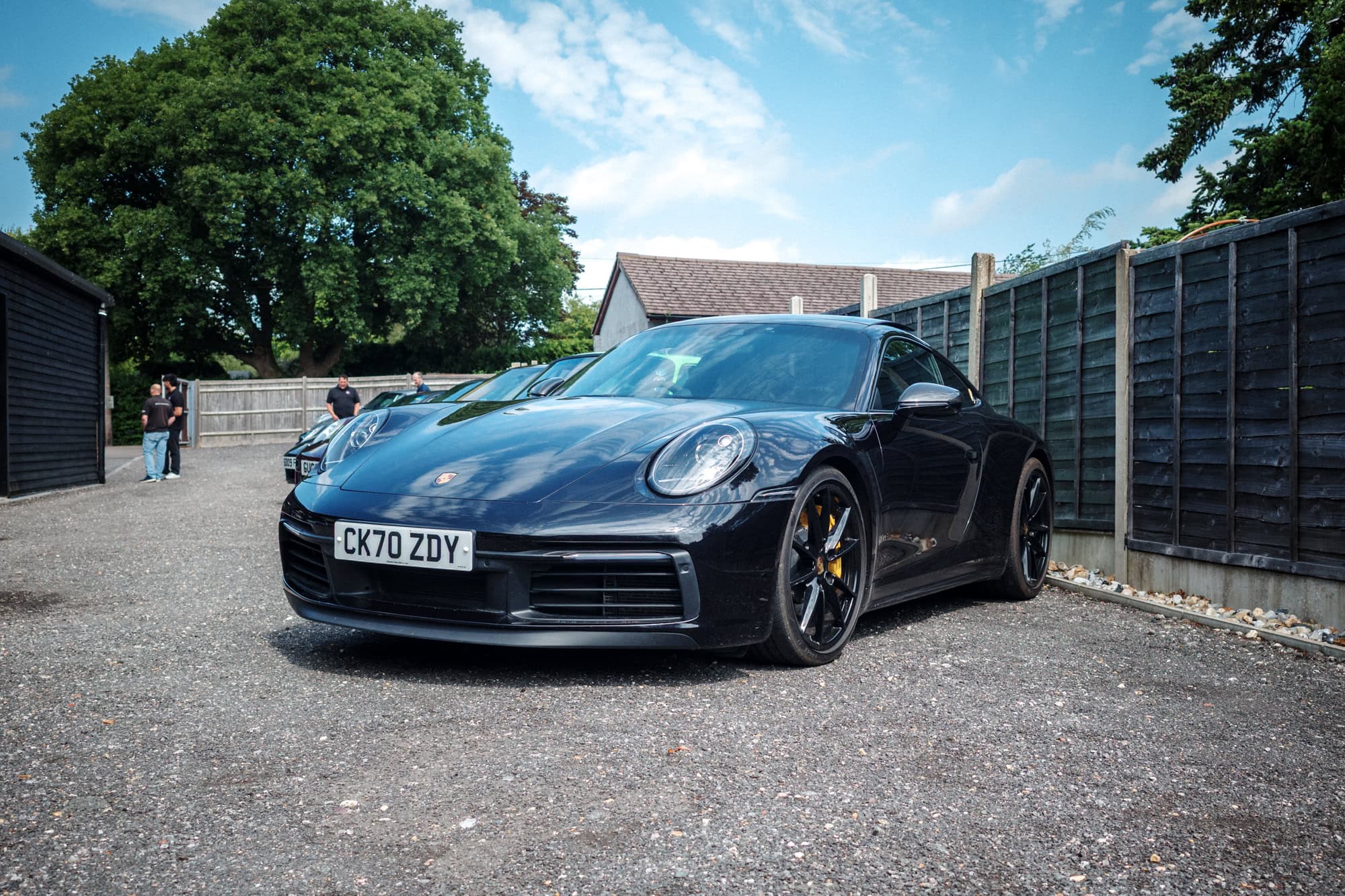 A black Porsche 992 coupe at the hero motor company open day.
