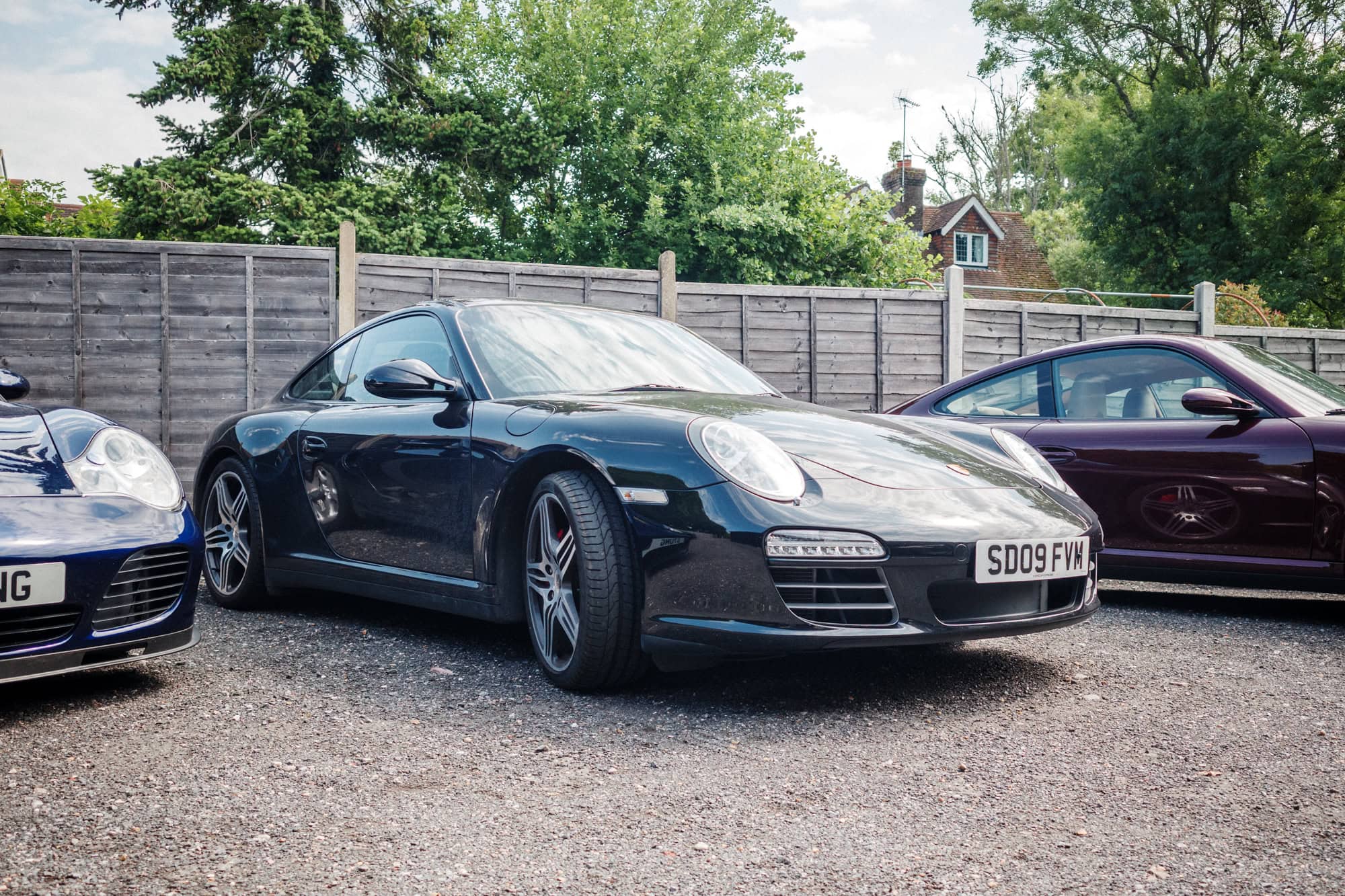 A black Porsche 997 Carrera at the hero motor company open day.