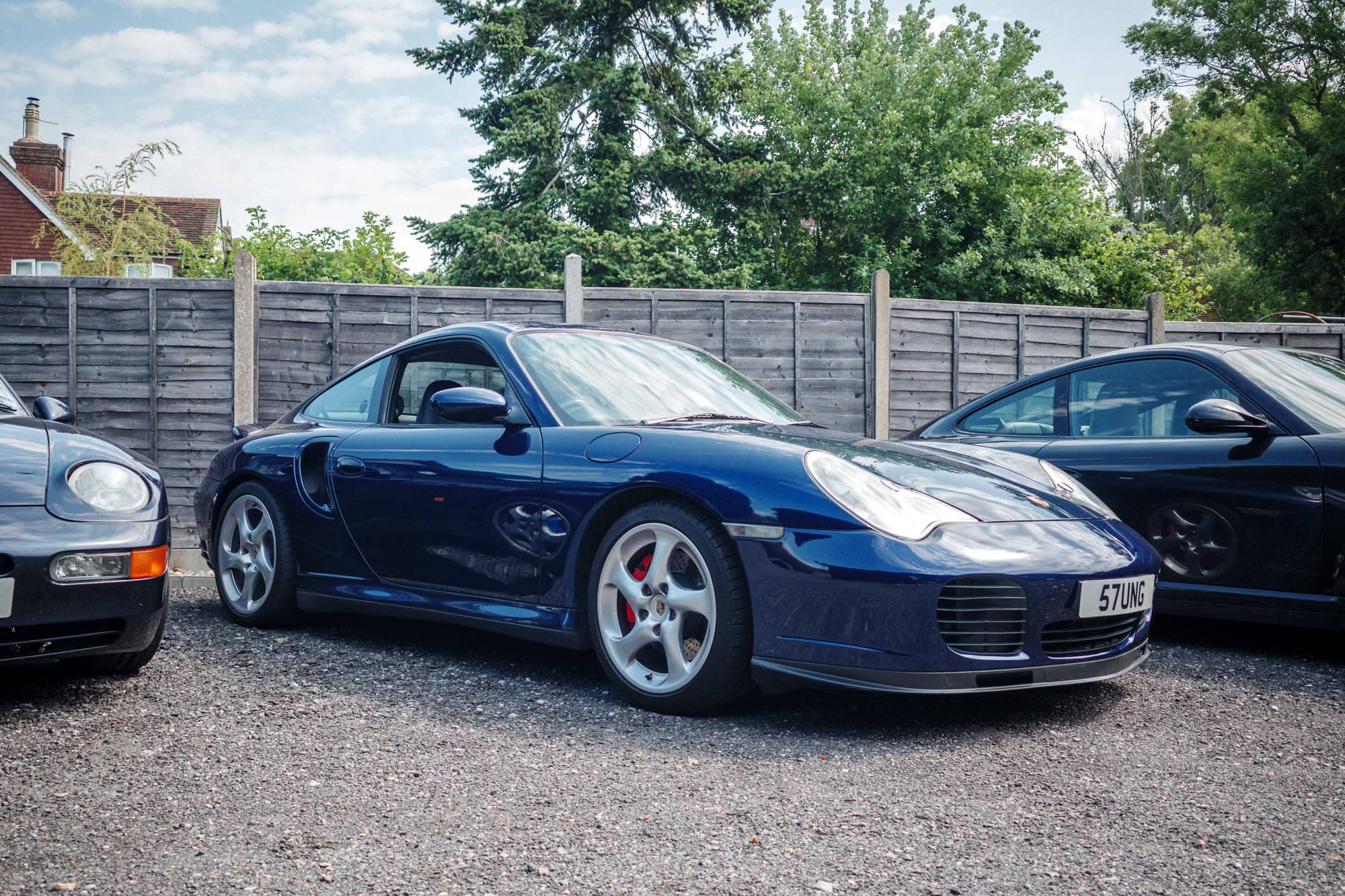 A navy blue Porsche 996 turbo coupe at the hero motor company open day.