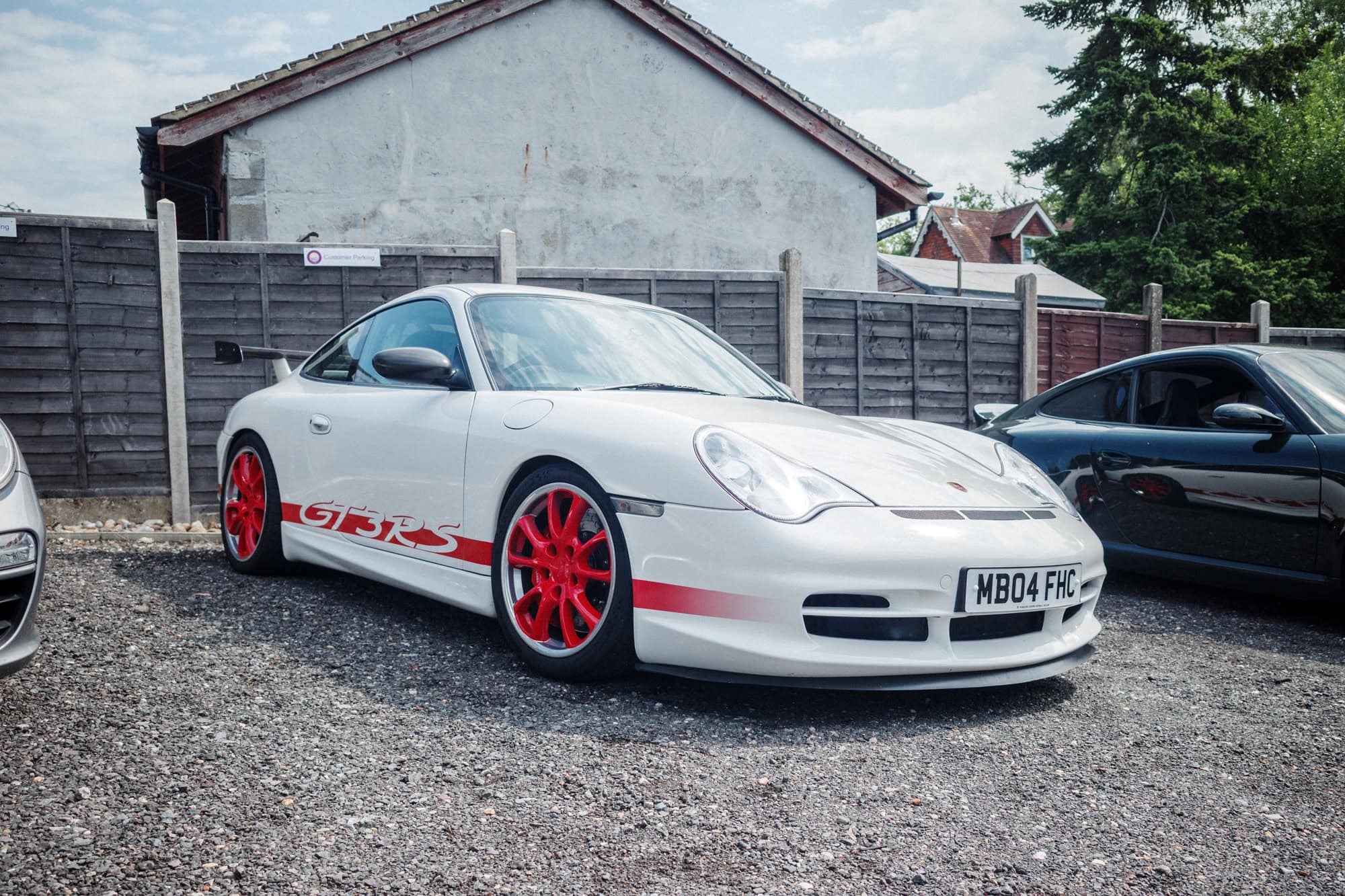 A white and red Porsche 996 GT3 RS at the hero motor company open day.