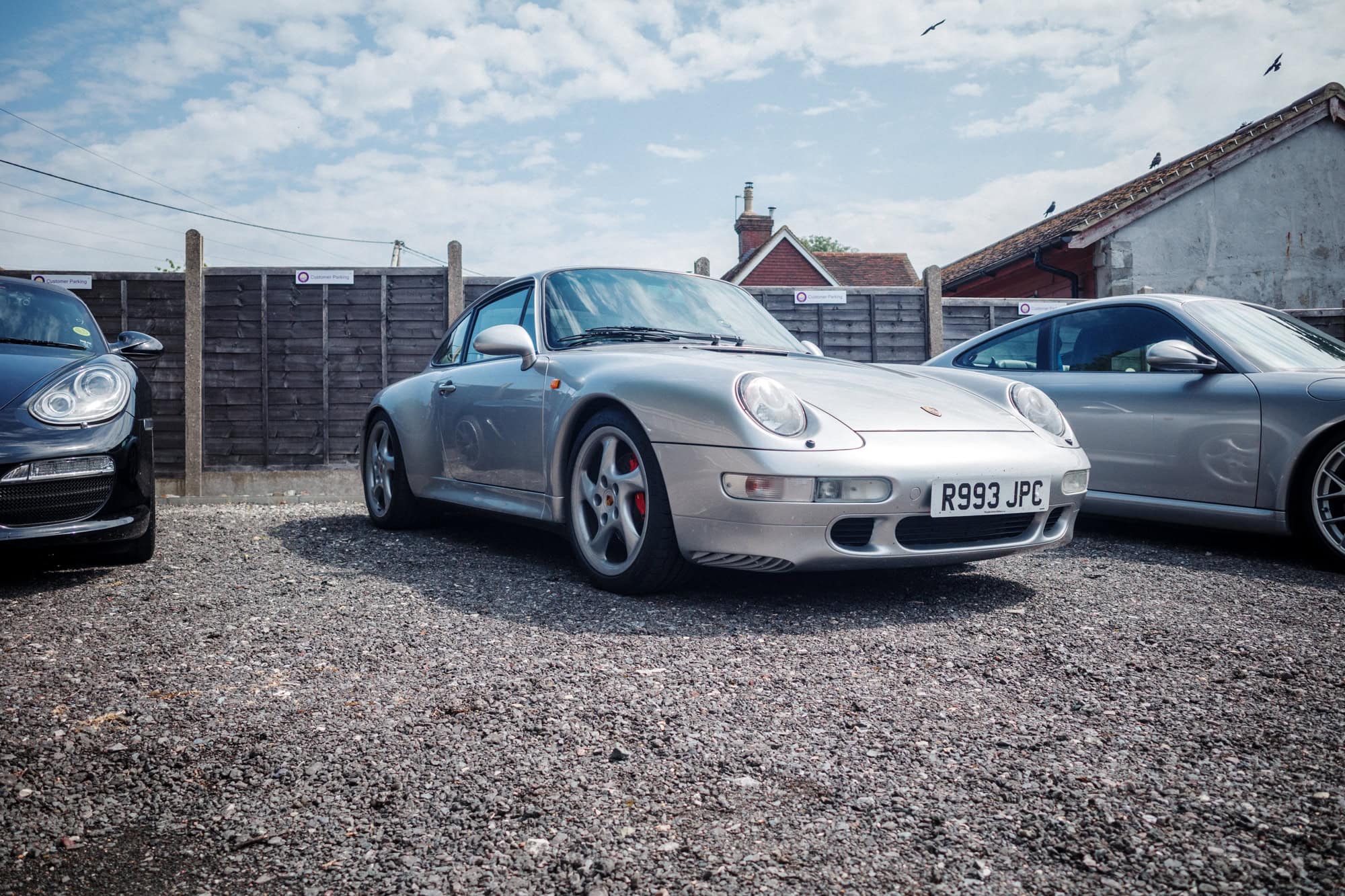 A silver Porsche 993 coupe at the hero motor company open day.