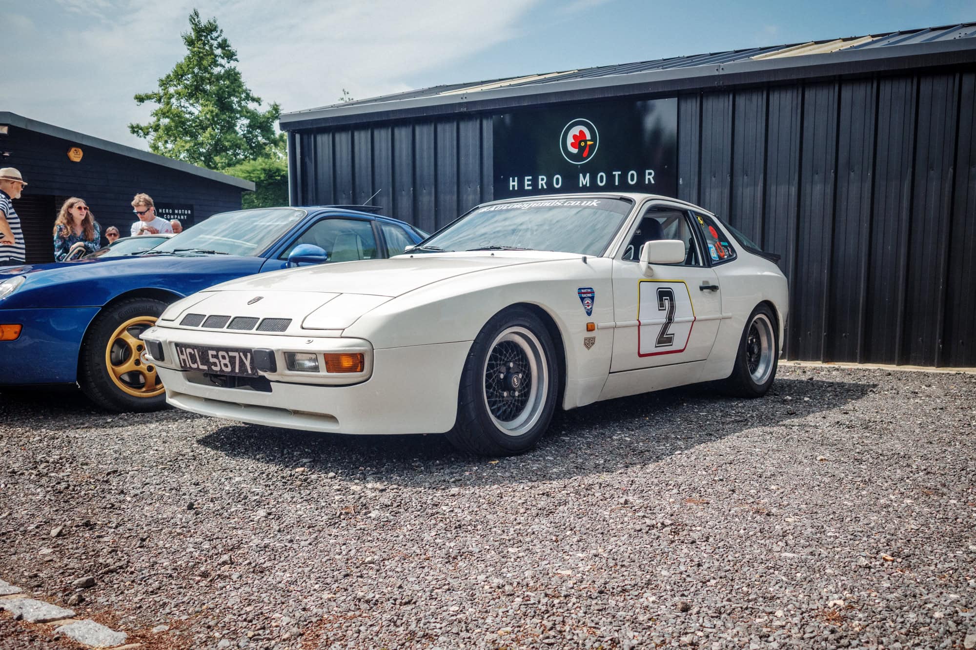 A beige Porsche 955 track car with black wheels at a Hero Motor Company open day.