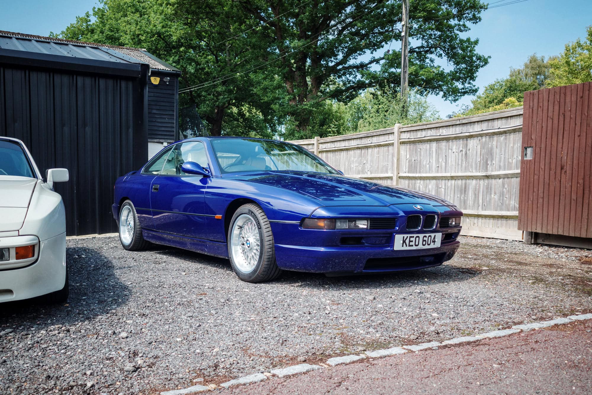 A blue BMW 850 Csi on split rim alloy wheels.