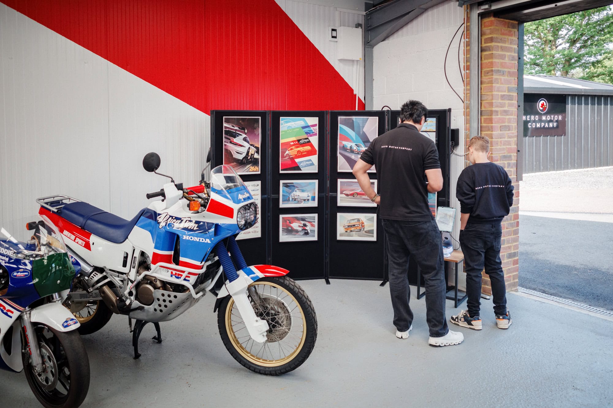 A display of artwork by Guy Allen at a hero motor company open day.