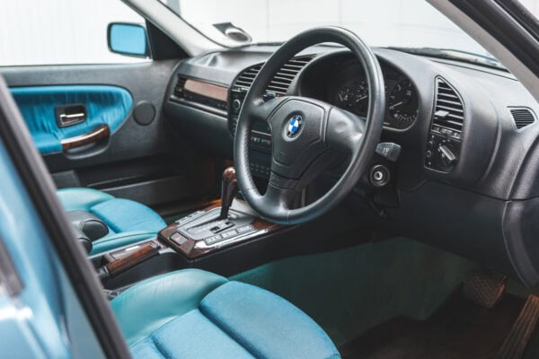 Offside interior showing steering wheel and centre console on BMW 1997 E36 523 TDS