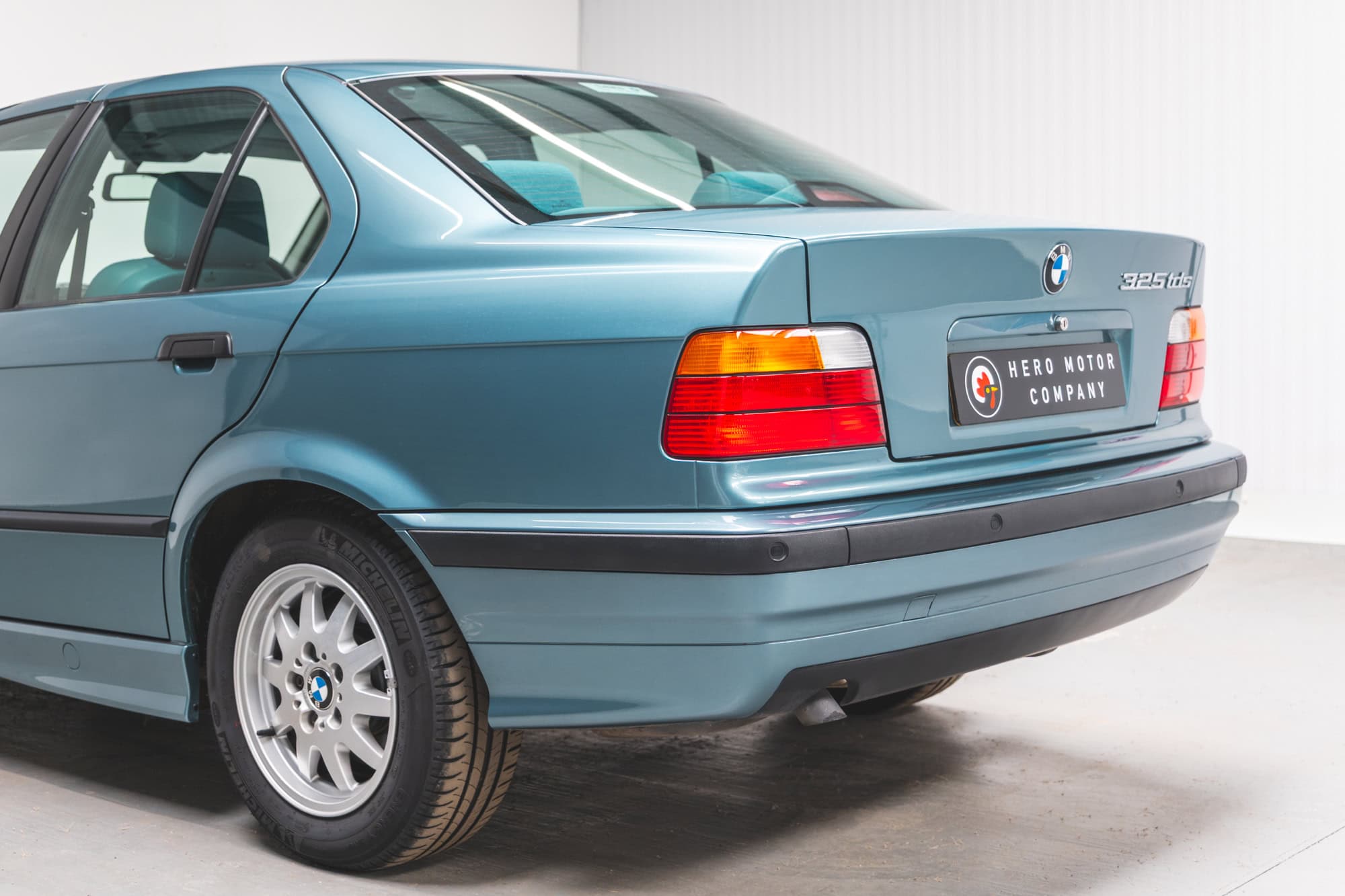 Close up view of rear near side exterior of a Morea Green BMW 1997 E36 523 TDS