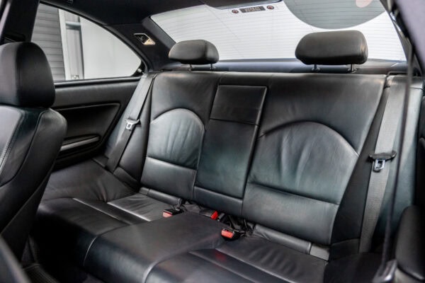 Rear black leather seats showing headrests on BMW E46 M3 in titan silver