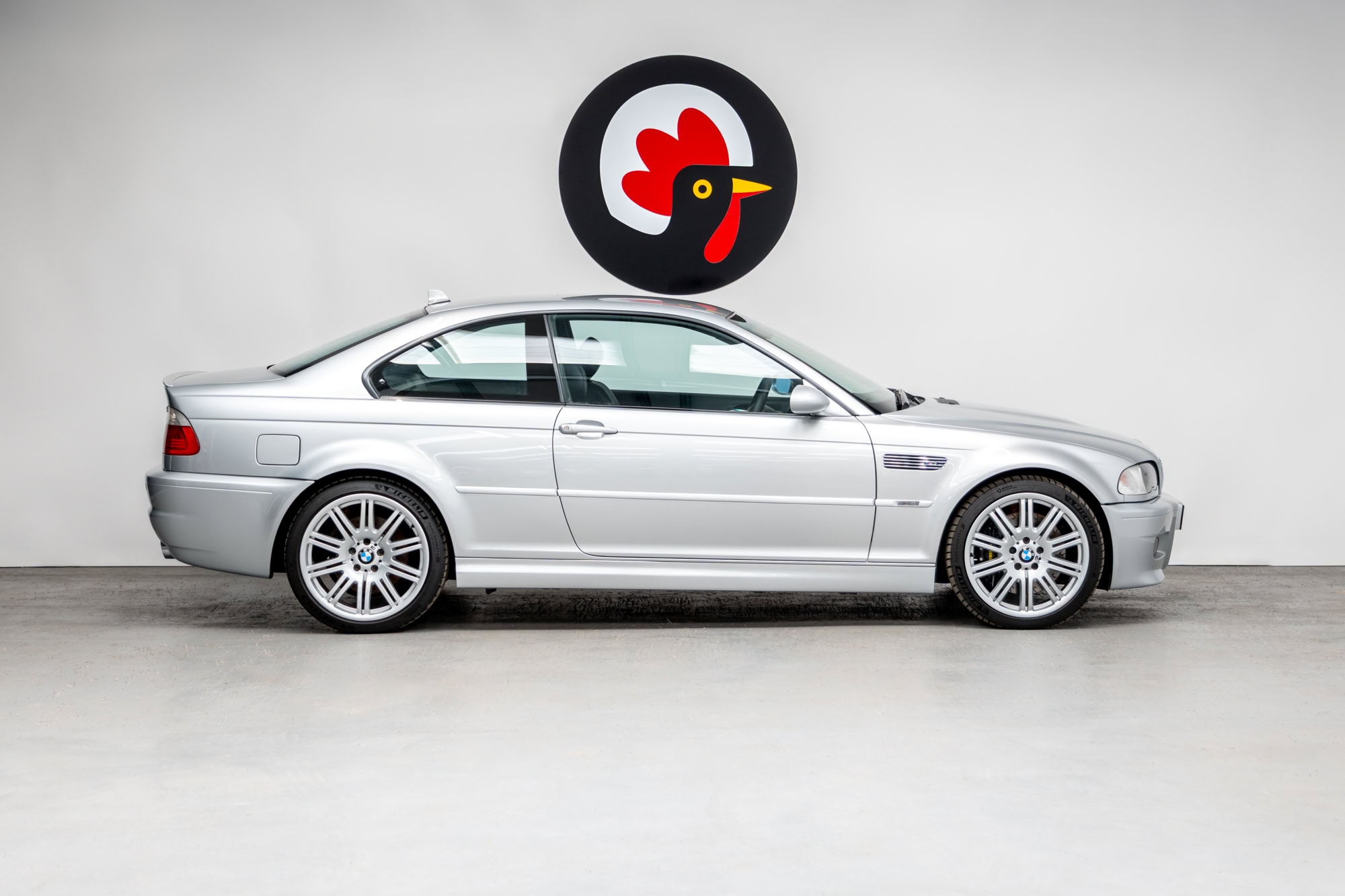 Offside exterior view of titan silver BMW E46 M3 showing allow wheels and chrome trim