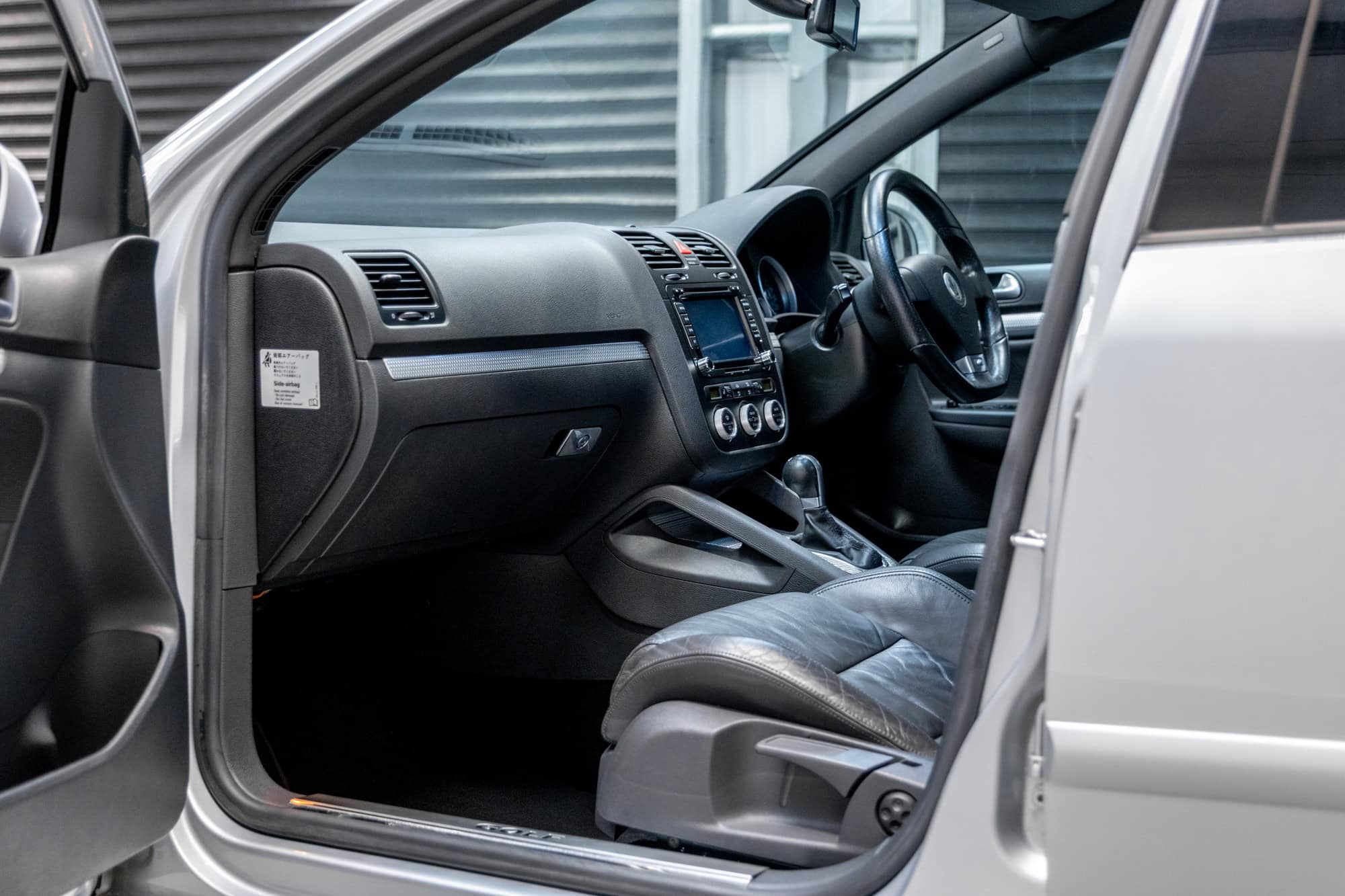 Nearside interior view showing dashboard centre console and steering wheel on Volkswagen Golf R32 Reflex Silver DSG