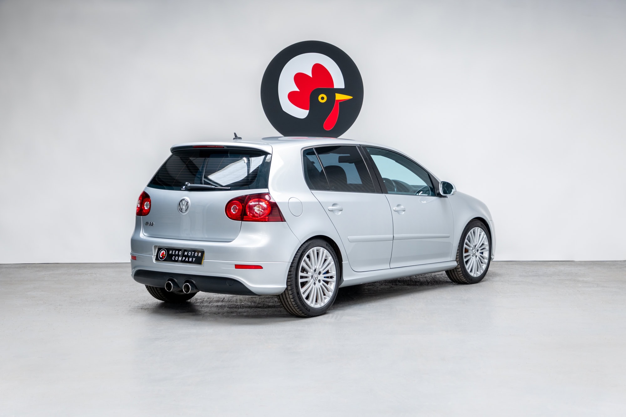 Rear offside exterior view of Reflex Silver Volkswagen Golf R32 showing alloy wheels and exhaust