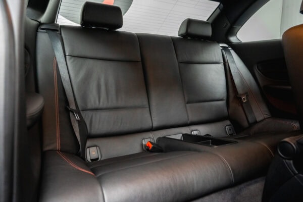 Black leather rear passenger seats on BMW E82 1M Coupe Valencia Orange