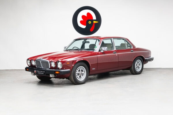 Nearside exterior front on 1985 Daimler Double Six Bordeaux Red Series 3 Saloon V12 showing chrome grill and trim