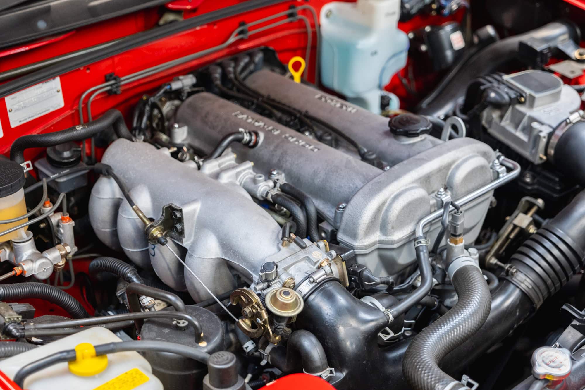 Close up view into engine bay on Mazda MX5 MKI Classic Red Eunos Roadster