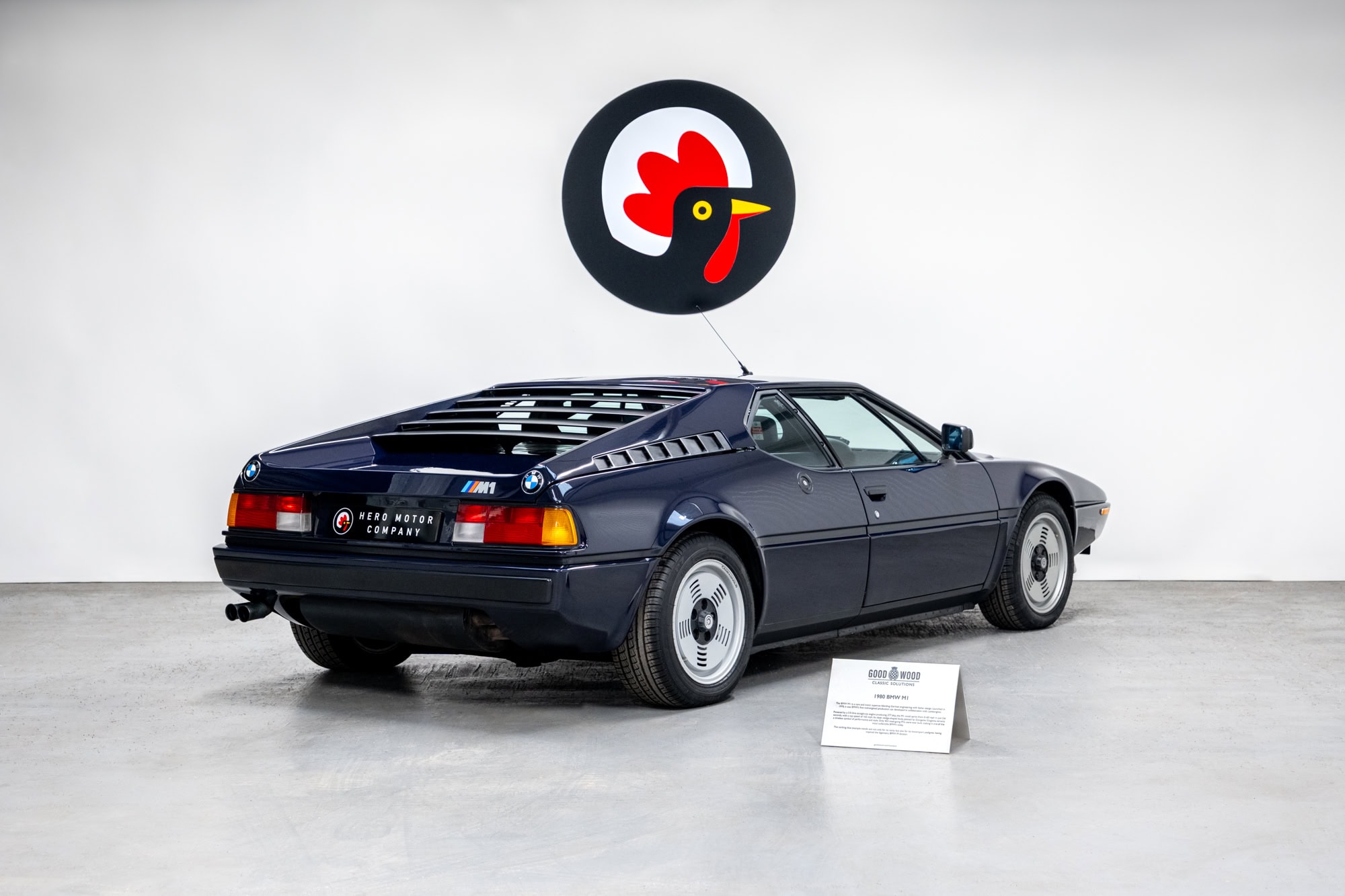 Rear offside exterior view with Goodwood sign of BMW E26 M1 1980 Nicht Blau