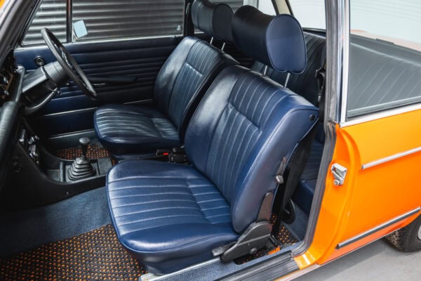 Passenger seat of a 1975 BMW 2002 tii in blue vinyl.