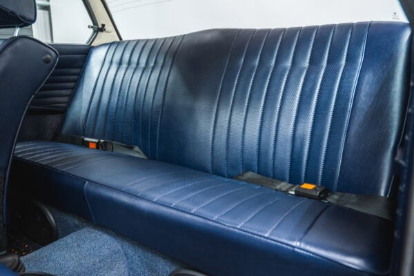 Blue vinyl rear seats of a 1975 BMW 2002 tii.
