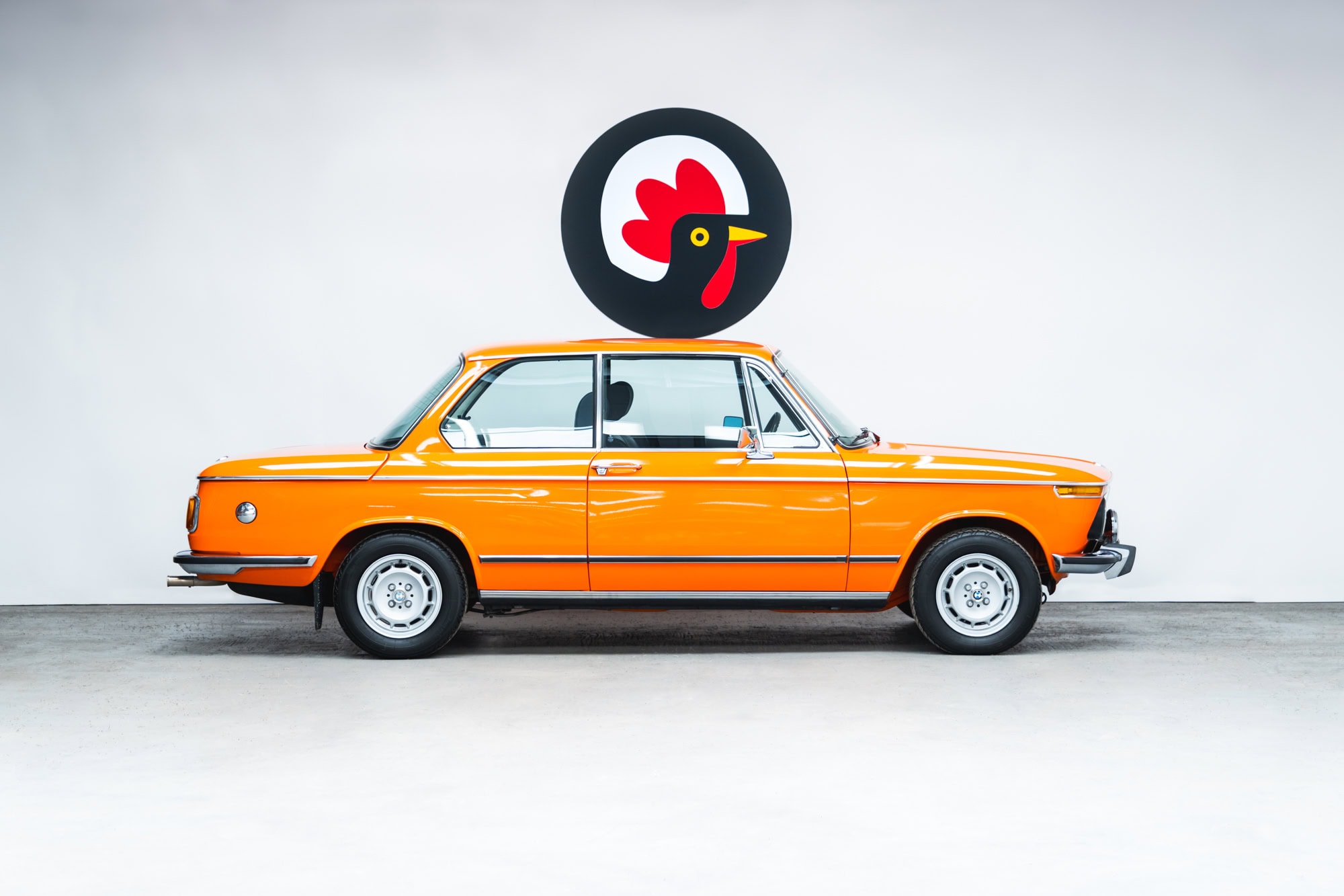 Offside profile of an Inka Orange BMW 2002 tii from 1975.