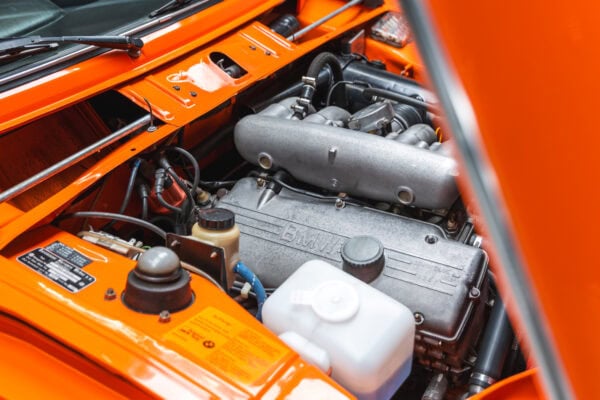 A cam cover and inlet manifold of a 1975 BMW 2002 tii.