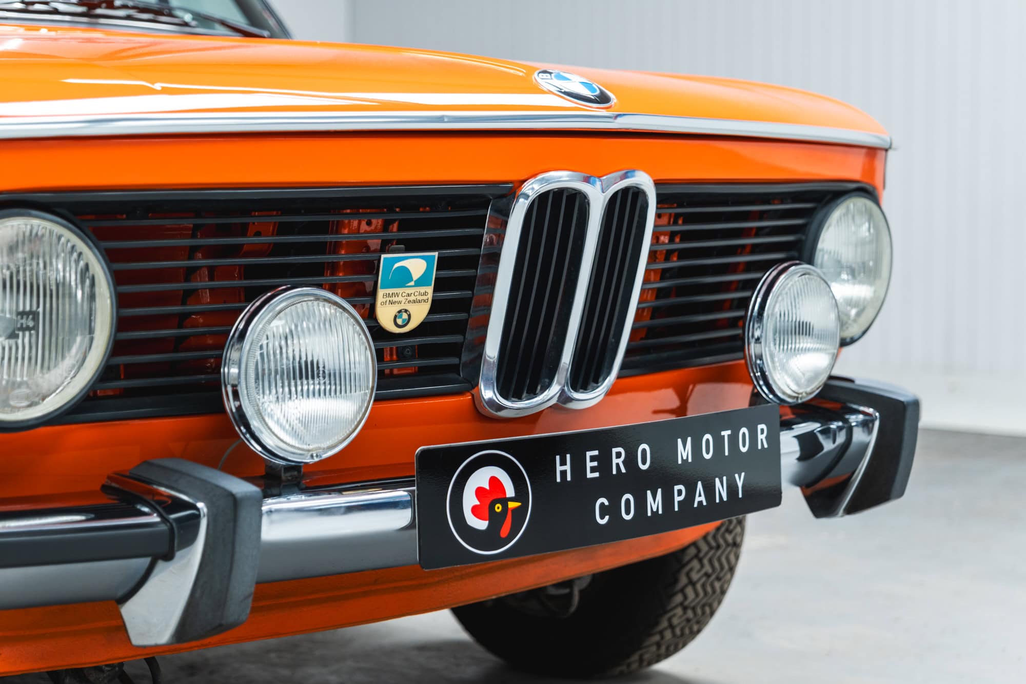 Front grill of an Inka Orange 1975 BMW 2002 tii.