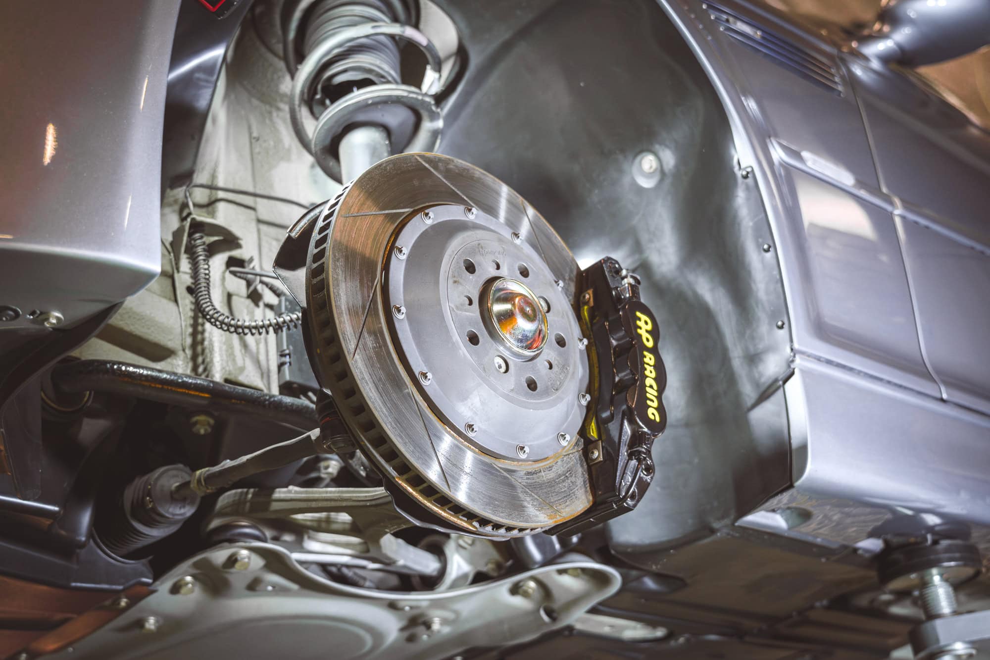 A brake disc and AP Racing caliper on an E46 M3 CSL.