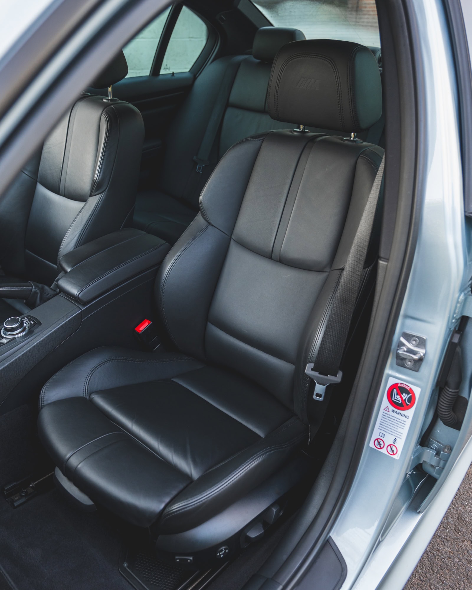 Nearside view into interior of BMW E90 M3 showing black leather seats