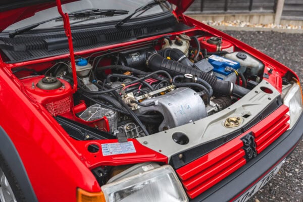Offside view into engine bay of cherry red Peugeot 205 GTI