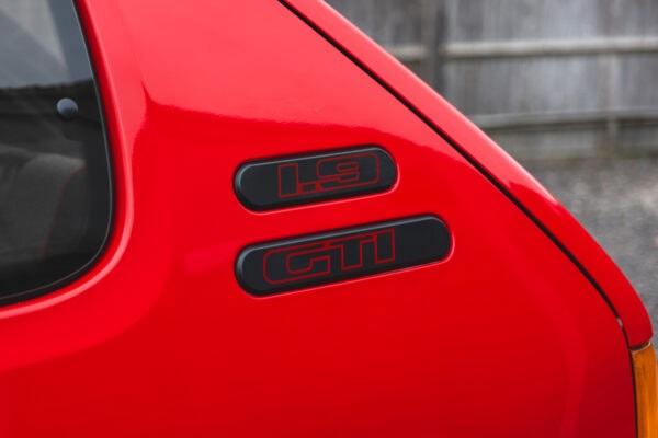 Close up view of 1.9 GTI logo on cherry red Peugeot 205 GTI