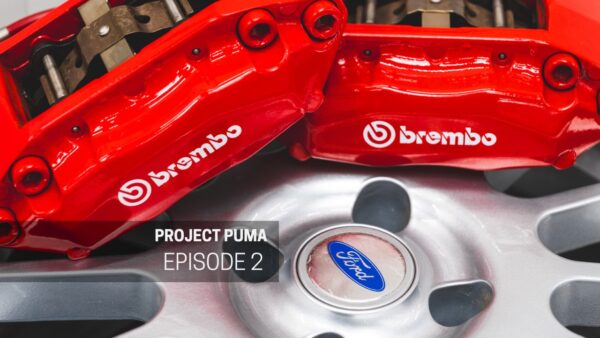 Two red Brembo brake calipers sit on a Ford Puma alloy wheel.