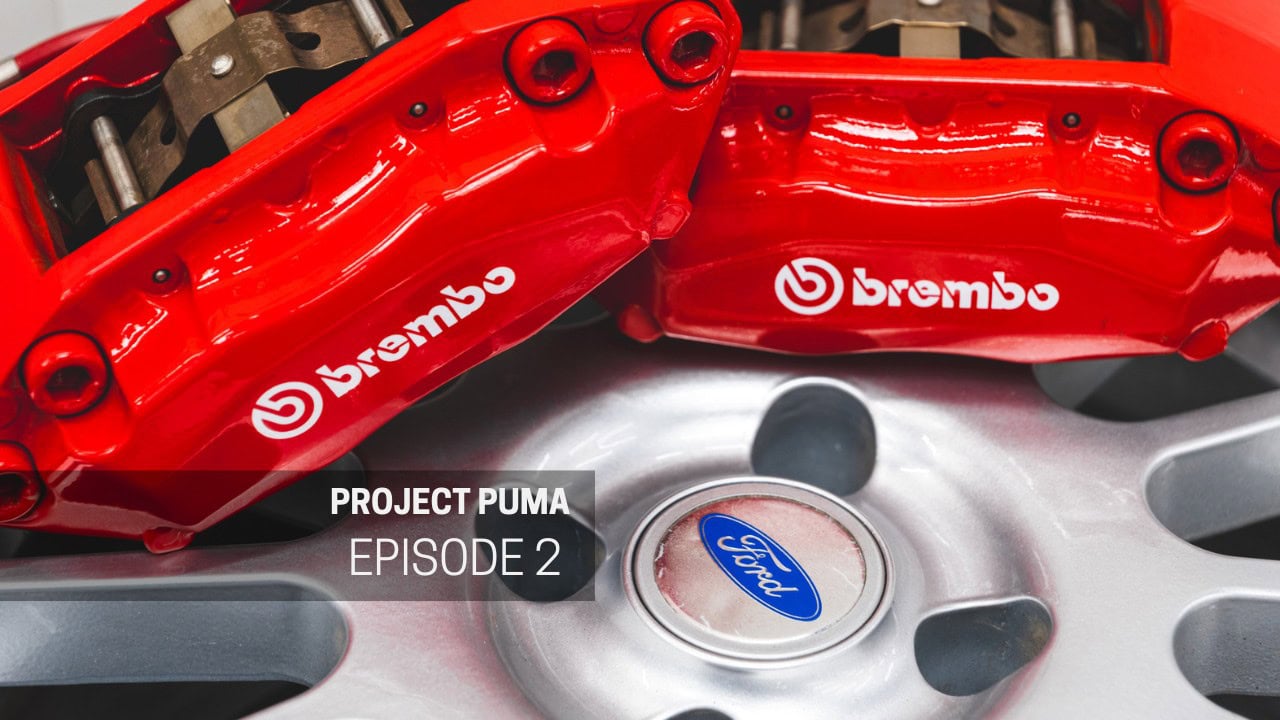 Two red Brembo brake calipers sit on a Ford Puma alloy wheel.