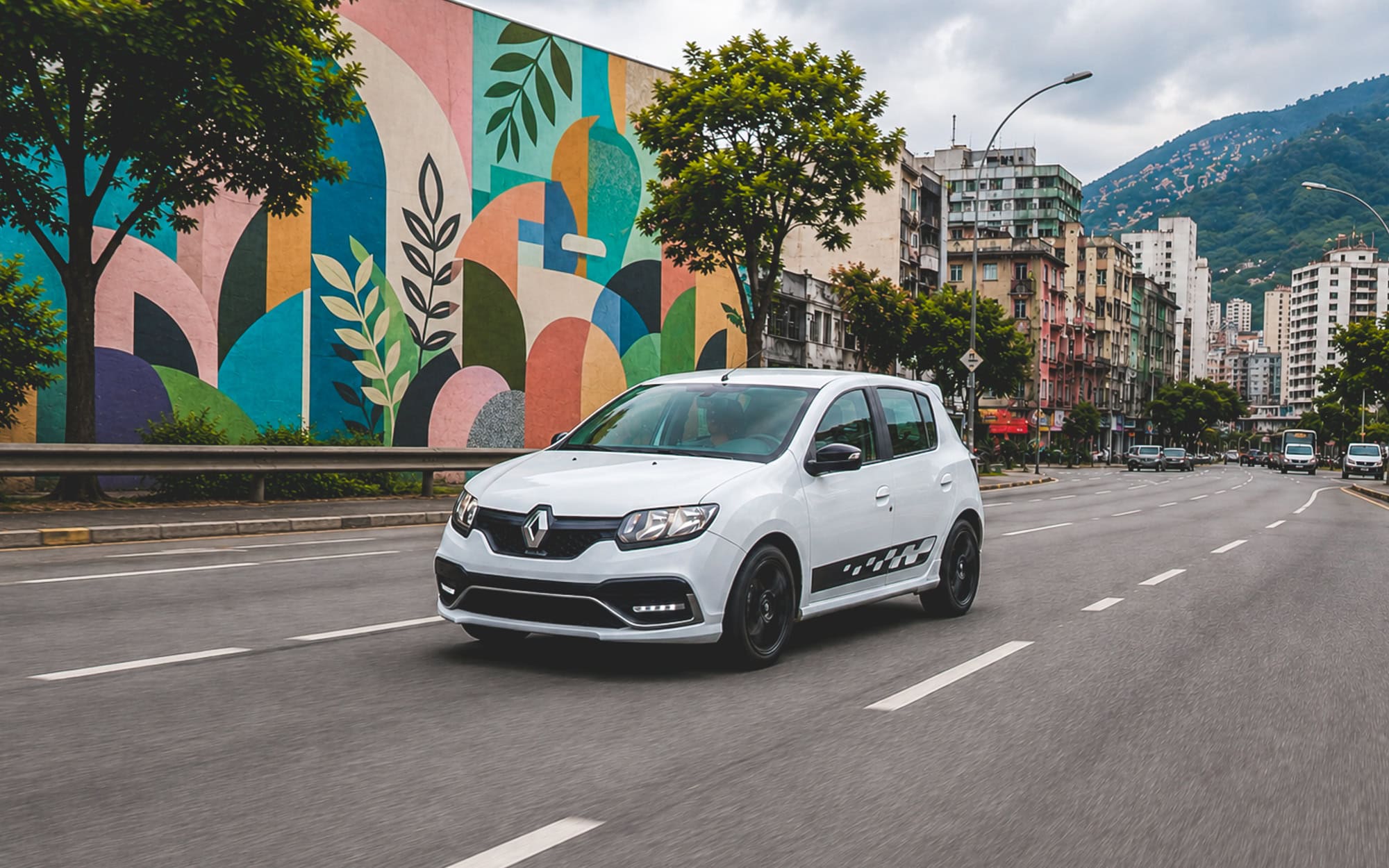A white Renault Sandero RS driving through a South American city.