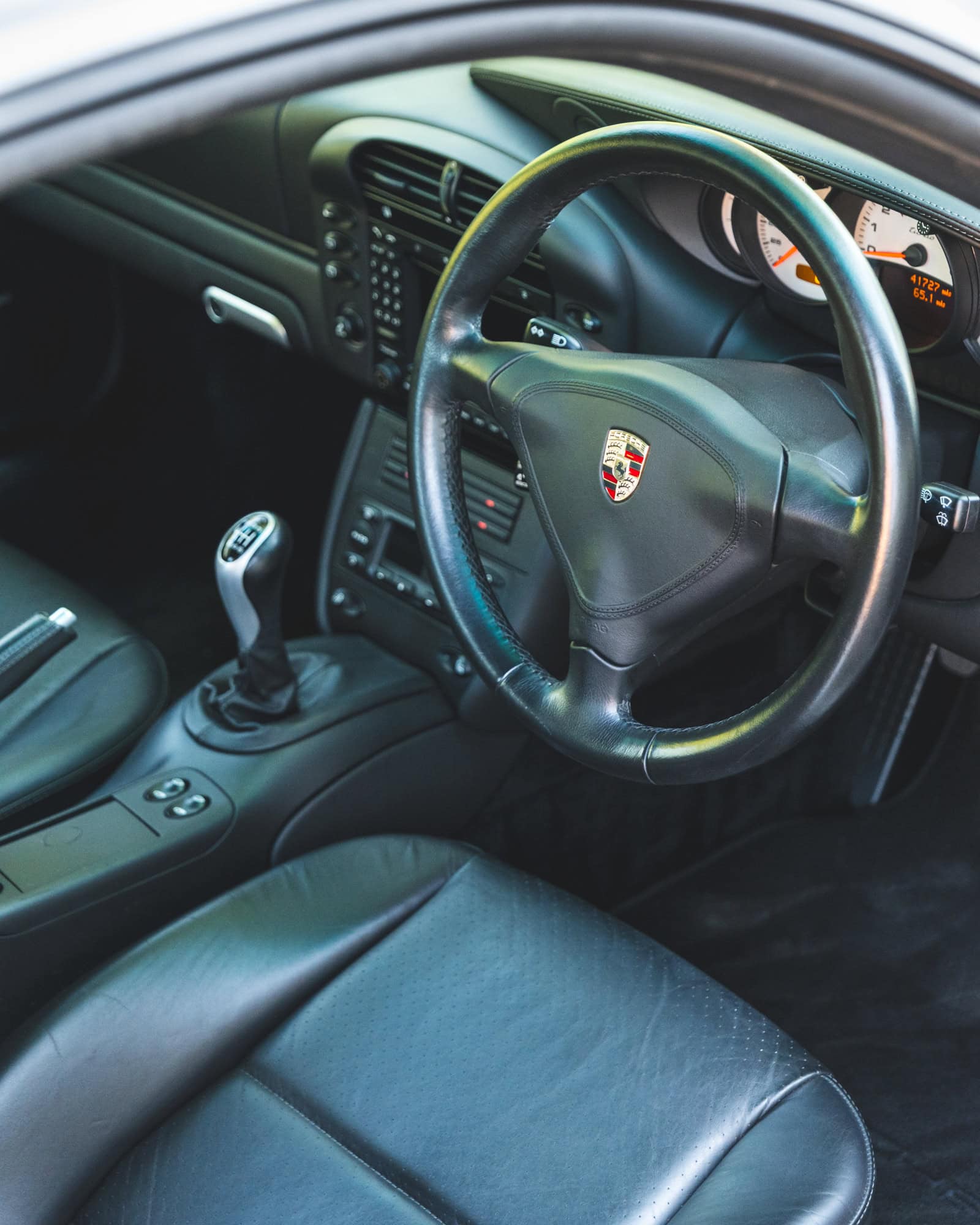 Black leather Porsche 996 interior and steering wheel.