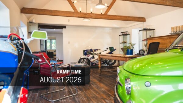 A cool office interior with classic racing motorcycles in a converted barn.
