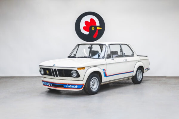 Front quarter view of a 1974 BMW 2002 Turbo in Chamonix White and Mahle Alloy Wheels.