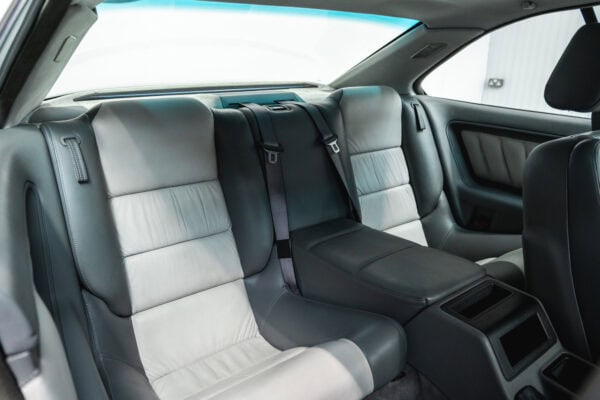 Rear drivers side seat of a BMW 850 CSI coupe in orient blue metallic with silver and grey leather interior.