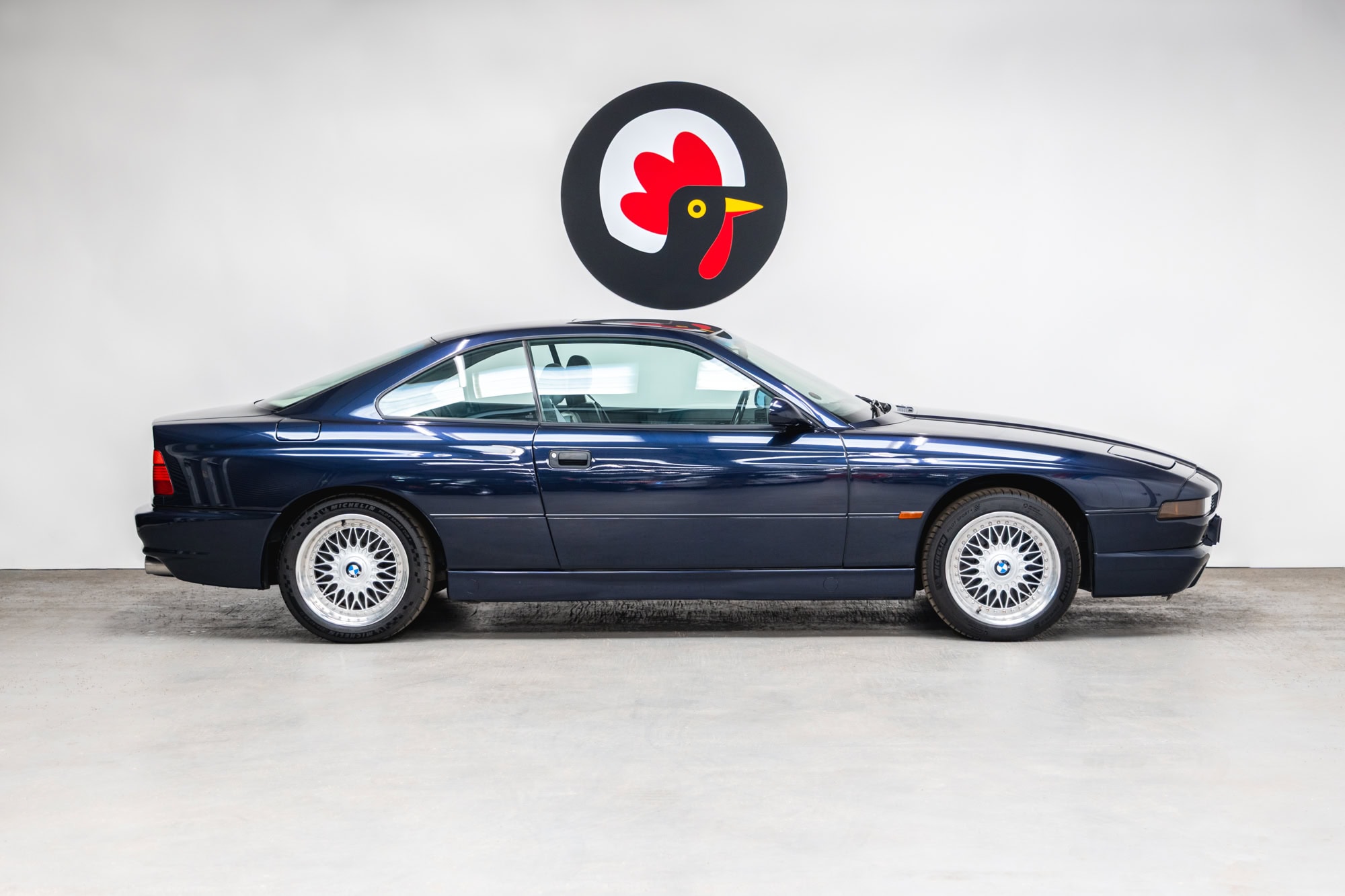 Offside profile of a BMW 850 CSI coupe in orient blue metallic on BBS split rim alloy wheels.
